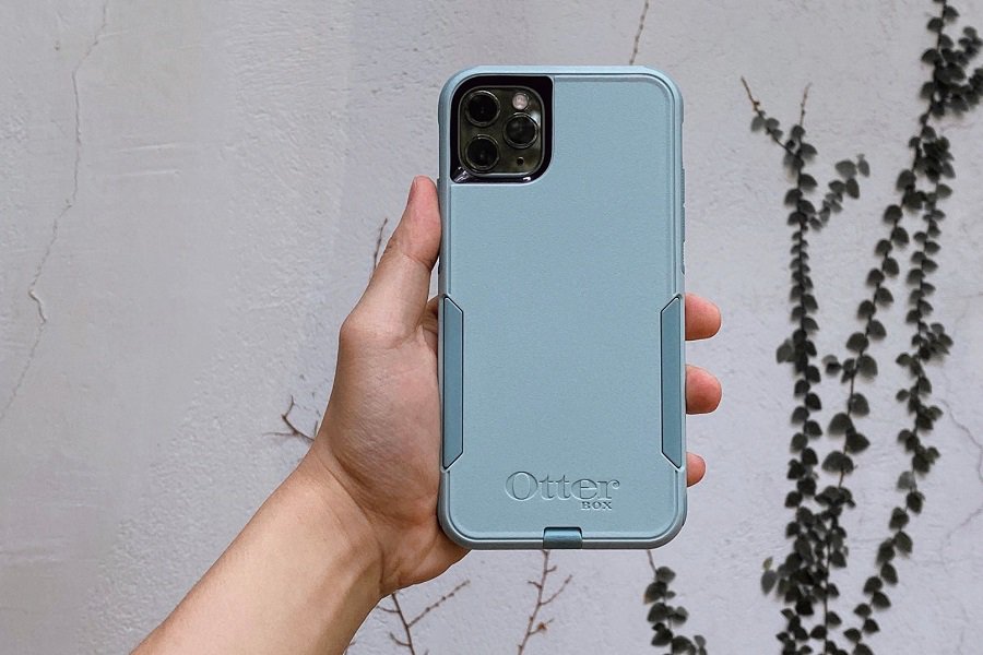Otterbox Prefix vs Commuter Close Up of a Person Holding Up a Phone in a Blue Case