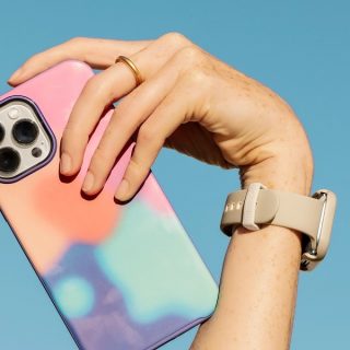 Otterbox Prefix vs Symmetry Person Holding Up Their Phone in a Colorful Case