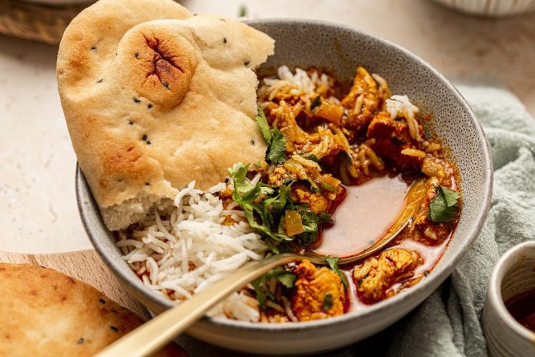 Easy Chicken Tikka Masala Recipe with Coconut Milk Close Up of a Bowl of Coconut Chicken Tikka Masala with Naan Bread