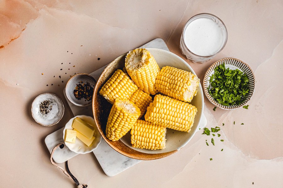 Slow Cooker Corn on the Cob with Coconut Milk Recipe Ingredients Laid Out on a Table