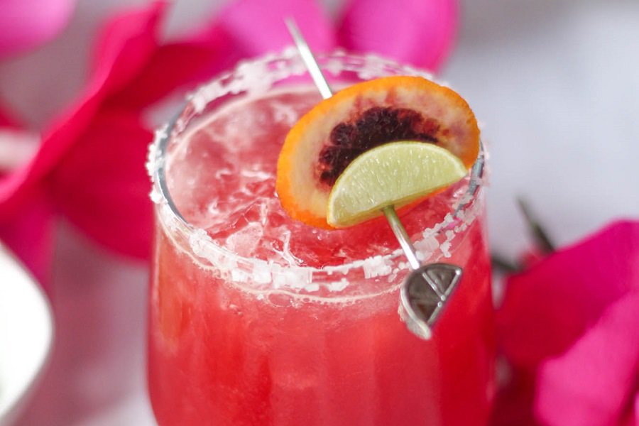Close Up of a Blood Orange Margarita Recipe in a Glass Garnished with Oranges and Limes