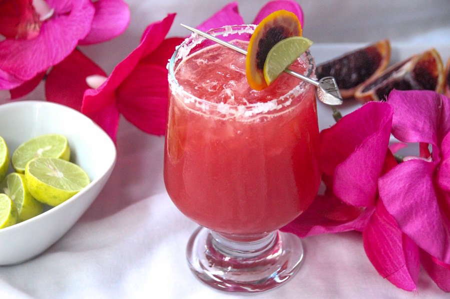 Blood Orange Margarita Recipe In a Glass Next to Bright Pink Flowers