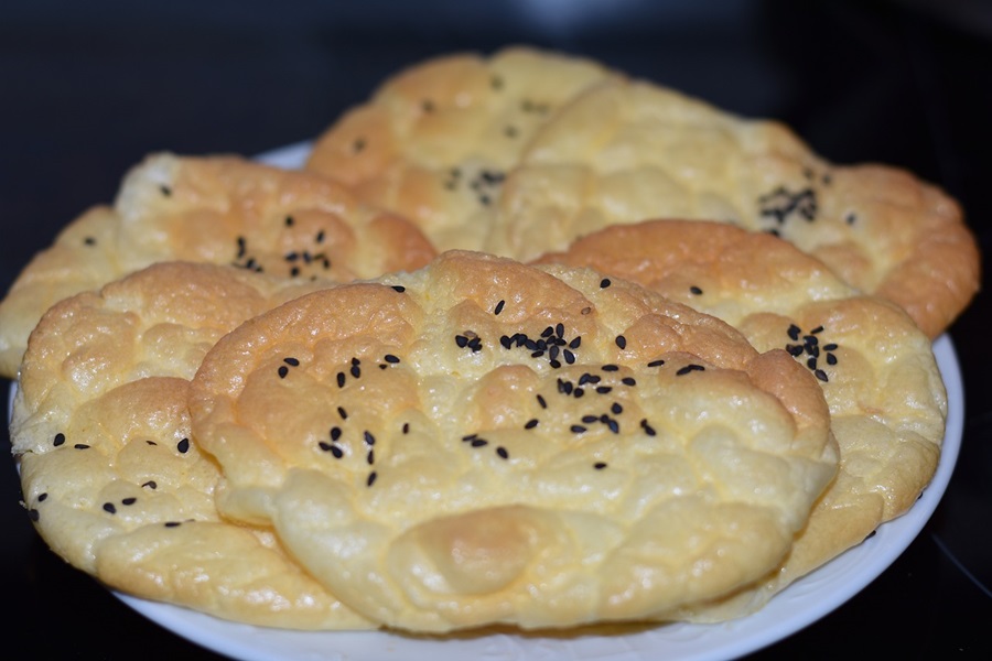 The Best Keto Bread Recipe Close Up of a Plate of Cloud Bread with Seeds On Them