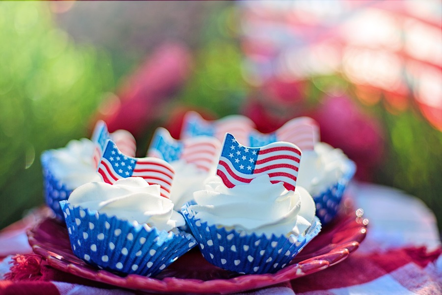 4th of July Party Ideas Close Up of a Plate of Cupcakes with American Flag Chocolates On Top