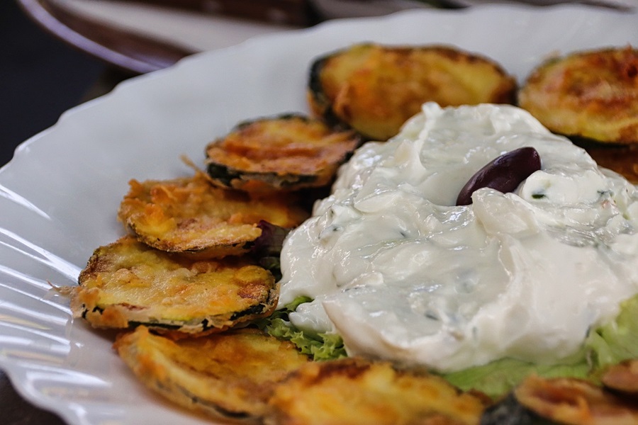 On the Go Keto Snacks Close Up of a Plate of Zucchini Chips and a Pile of Dip in the Center