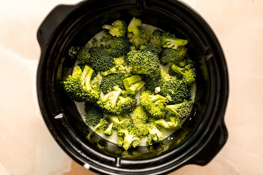 Slow Cooker Chicken Broccoli and Rice Casserole Inside of a Slow Cooker Filled with Broccoli