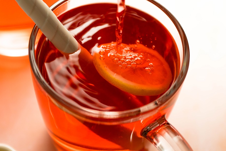Jillian Michaels Detox Drink Recipe View of Someone Pouring Cranberry Juice into a Glass of Tea