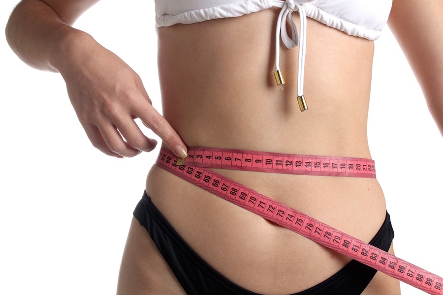 Nutrisystem Diabetic Meal Plan Tips and Tricks  Close Up of a Woman Wrapping a Pink Measuring Tape Around Her Waist