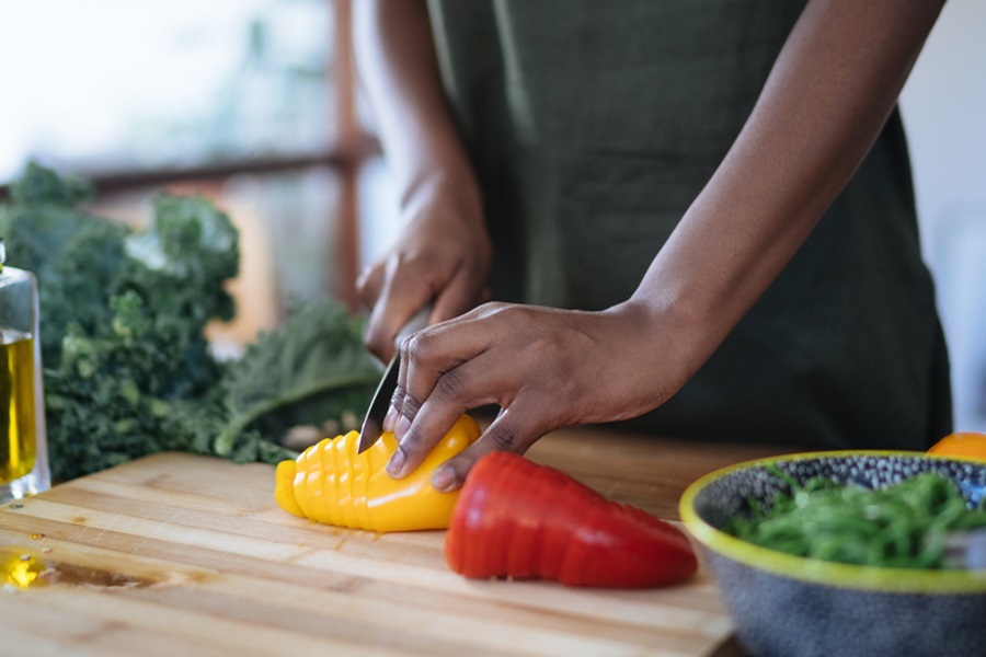 Nutrisystem Diabetic Meal Plan Tips and Tricks  Close Up of a Person Cutting a Yellow Bell Pepper on a Cutting Board in Their Kitchen