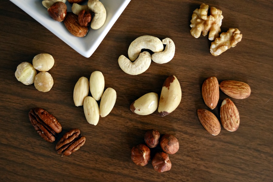 Best Dairy-Free Meal Replacement Shakes Cashews, Almonds, Walnuts, and Cashews on a Wooden Surface