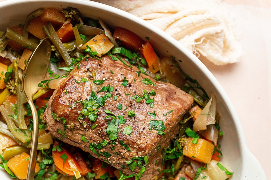Old Fashioned Pot Roast Recipe in the Slow Cooker Overhead View of a Pot Roast with Veggies in a Serving Dish