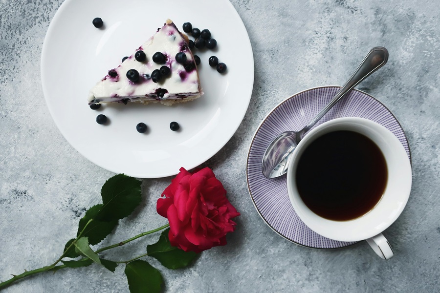 Jillian Michaels Bodyshred Meal Plan a Piece of Cake on a Plate Topped with Blueberries Next to a Rose and a Cup of Coffee