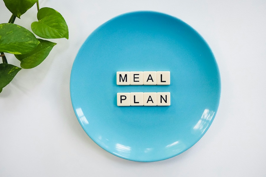 Jillian Michaels Bodyshred Meal Plan a Blue Plate with Letter Tiles Spelling "Meal Plan"
