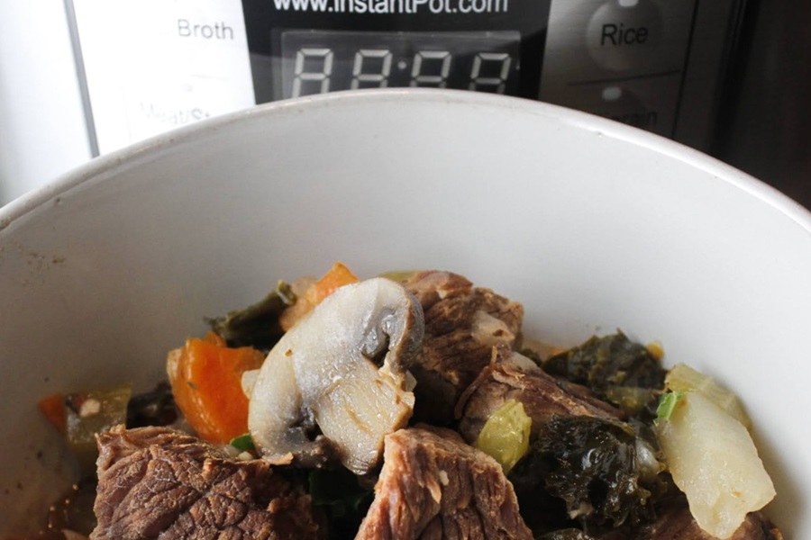 Slow Cooker Low Carb Beef Stew Recipe Close Up of a Bowl of Beef Stew Next to an Crock Pot