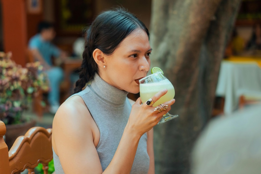 Limeade Margarita Recipe Ideas a Woman Drinking a Margarita Outdoors