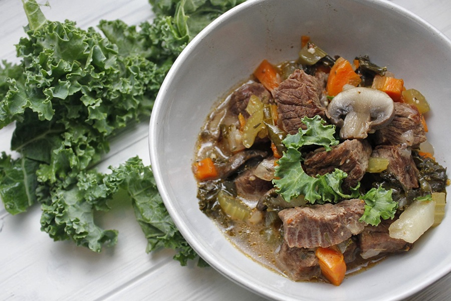 Slow Cooker Low Carb Beef Stew Recipe a Bowl of Beef Stew with a Kale Leaf Next to it