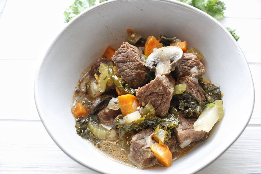 Slow Cooker Low Carb Beef Stew Recipe Close Up of a Bowl of Beef Stew with Kale, Mushrooms, and Carrots