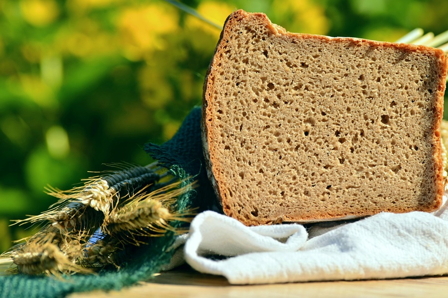 Is Gluten Free Bread Good for Diabetics Close Up of a Loaf of Bread with a Slice Cut Off Next to Wheat