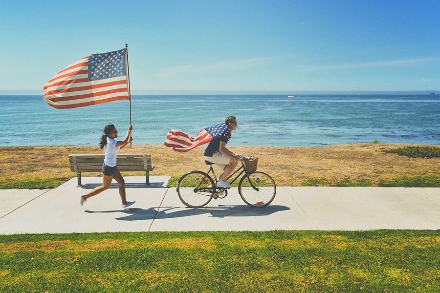 Low Carb Fourth of July Desserts Two People Riding Bikes Along a Beach Holding American Flags