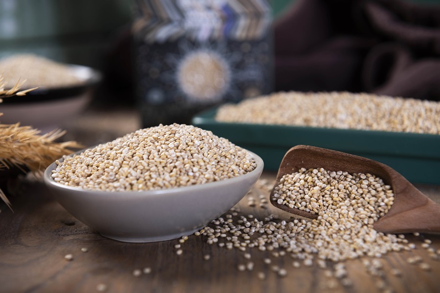 Easy Quinoa Recipes for Diabetics a Bowl of Quinoa Spilling Over on a Wooden Table