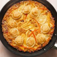 Healthy and Easy Breakfast Skillet Recipe with Potatoes Overhead View of a Skillet with Eggs, Potatoes, and Cheese Inside