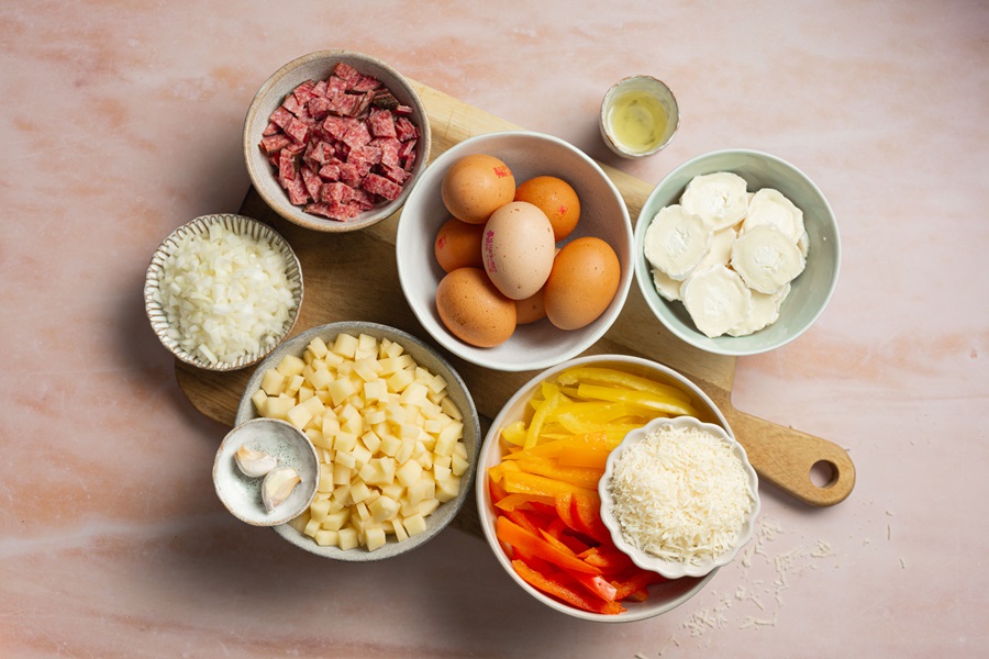 Healthy and Easy Breakfast Skillet Recipe with Potatoes Ingredients Separated into Bowls on a Counter Top