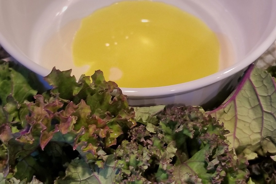 Easy Air Fryer Kale Chips Recipe Close Up of Kale Next to a Bowl of Oil and Salt 