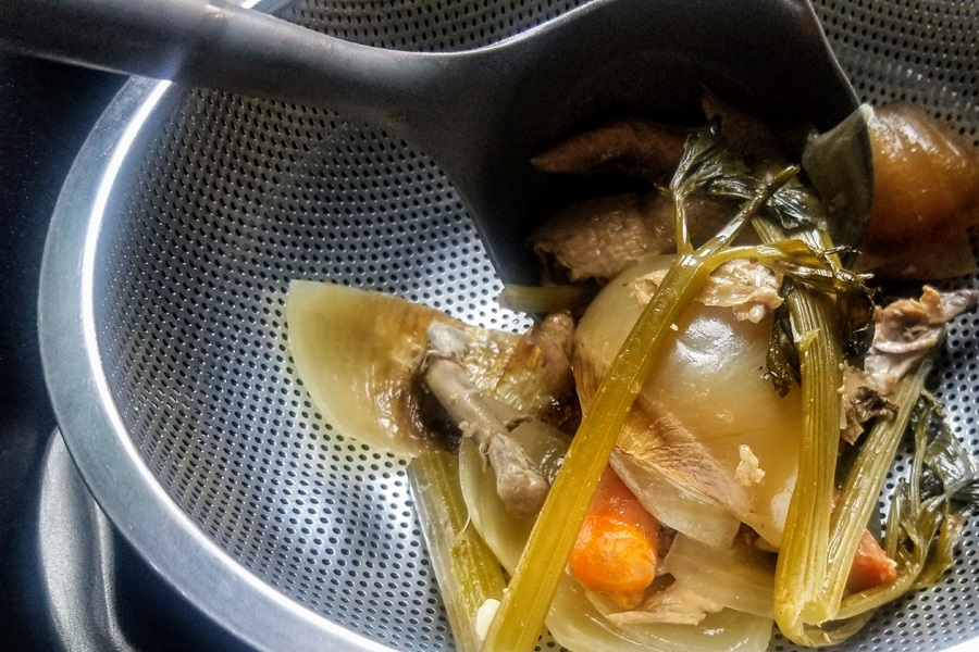 Healing Chicken Bone Broth Recipe Close Up of Veggies in a Strainer