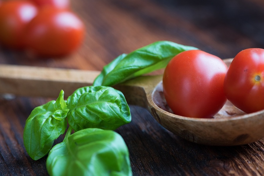 Jillian Michaels 30 Day Shred Meal Plan Close Up of a Wooden Spoon with Small Tomatoes Inside and a Basil Sprig