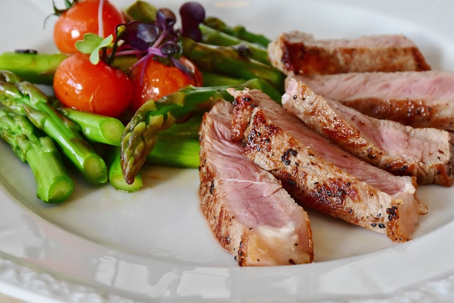 Jillian Michaels 30 Day Shred Meal Plan Close Up of a Plate of Cooked Pork with an Asparagus Salad