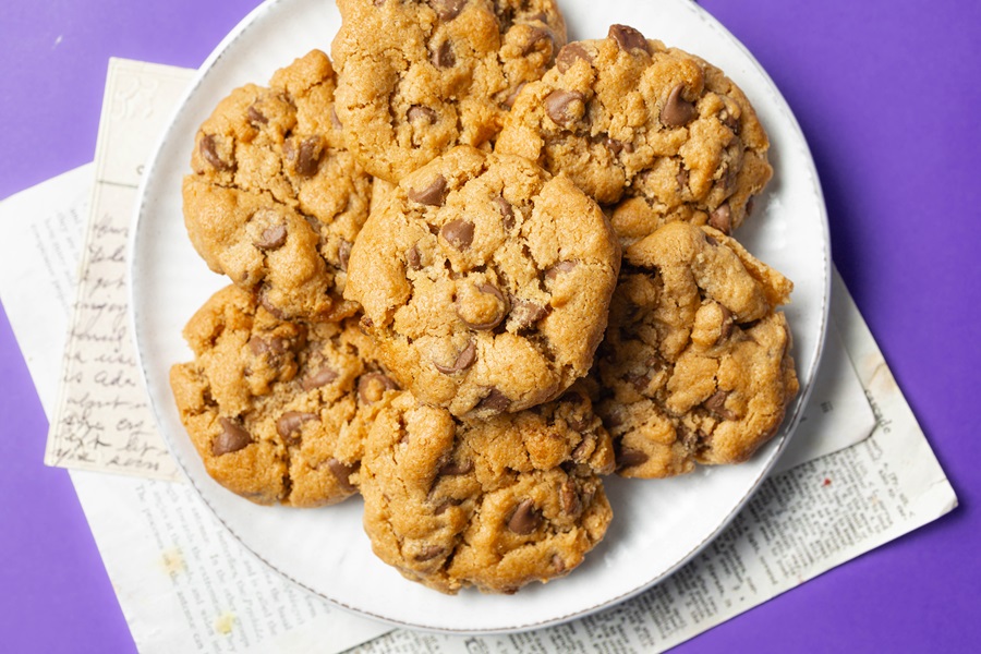 Air Fryer Peanut Butter Cookies without Flour a Plate of Cookies on a Purple Surface with Papers