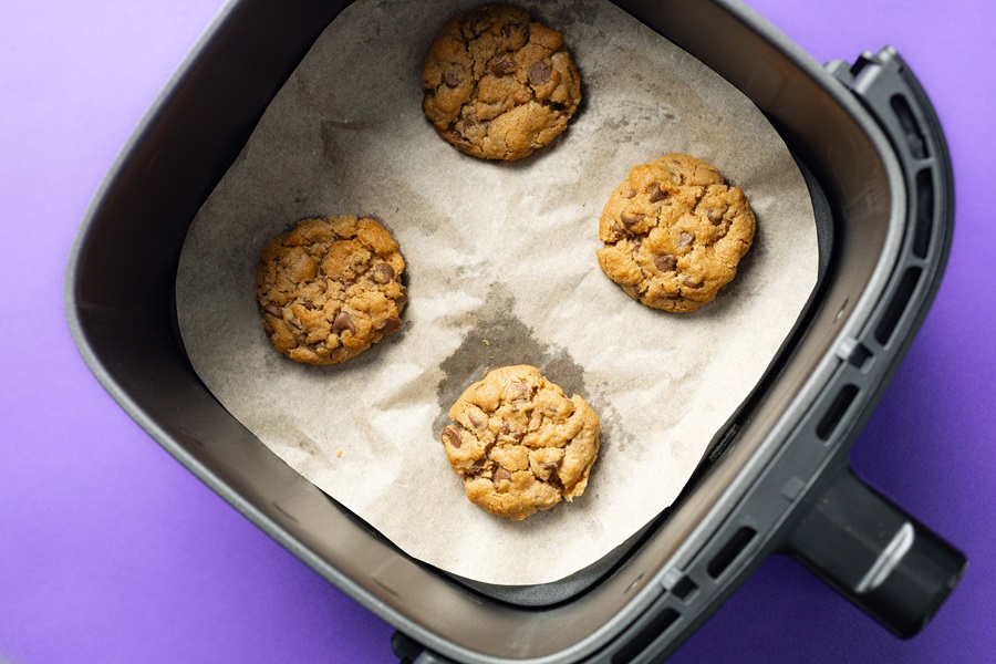 Air Fryer Peanut Butter Cookies without Flour Cookies on Parchment Paper Inside an Air Fryer Basket