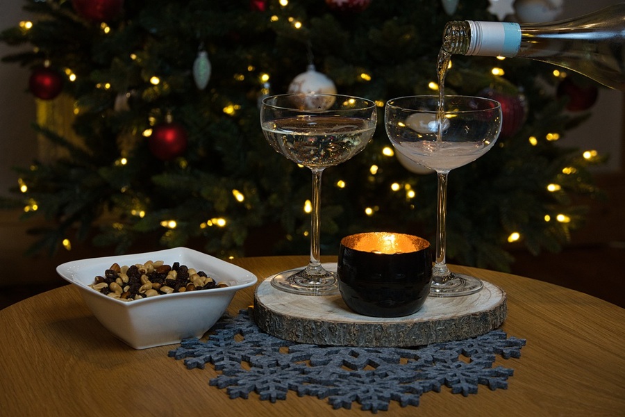 Easy Cocktails with Champagne Two Champagne Glasses with Champagne Being Poured into One of the Glasses