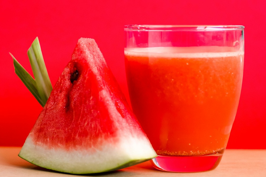 Fat Burning Juice Recipes  Close Up of a Glass of Watermelon Juice Next to a Wedge of Watermelon