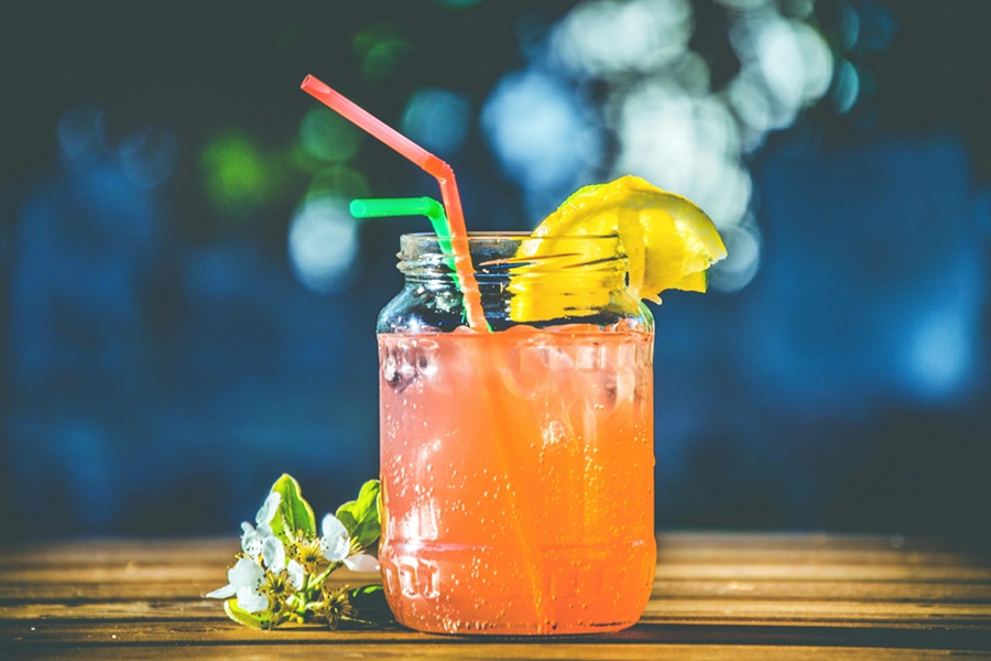 Fat Burning Juice Recipes  Close Up of a Small Mason Jar Filled with Juice and Garnished with a Lemon Slice