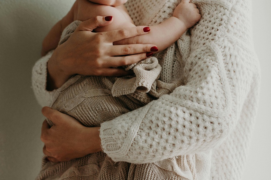 Healthy Mothers Day Breakfast Ideas Close Up of a Mother Holding Her Baby Tightly Against Her Chest