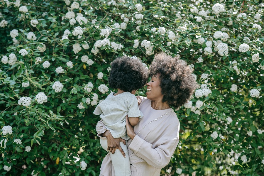 Healthy Mothers Day Breakfast Ideas a Mom Holding Her Child Next to a Bush Filled with Flowers