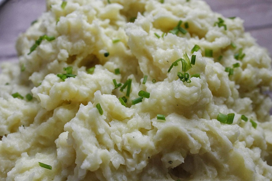 Close Up of 15 Minute Instant Pot Mashed Potatoes in a Glass Bowl Topped with Chives