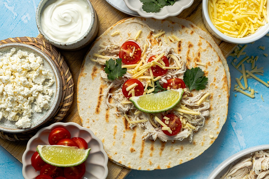 Easy Chicken Tacos with Shredded Chicken a Plate of Tortillas with Taco Ingredients On Top