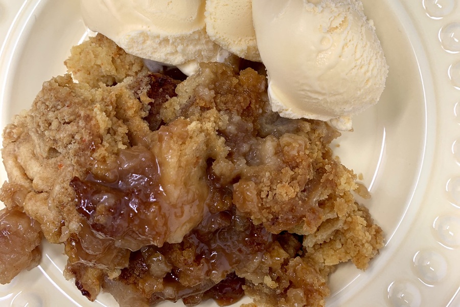 Close Up of Crockpot Apple Crisp with Vanilla Ice Cream on a Plate