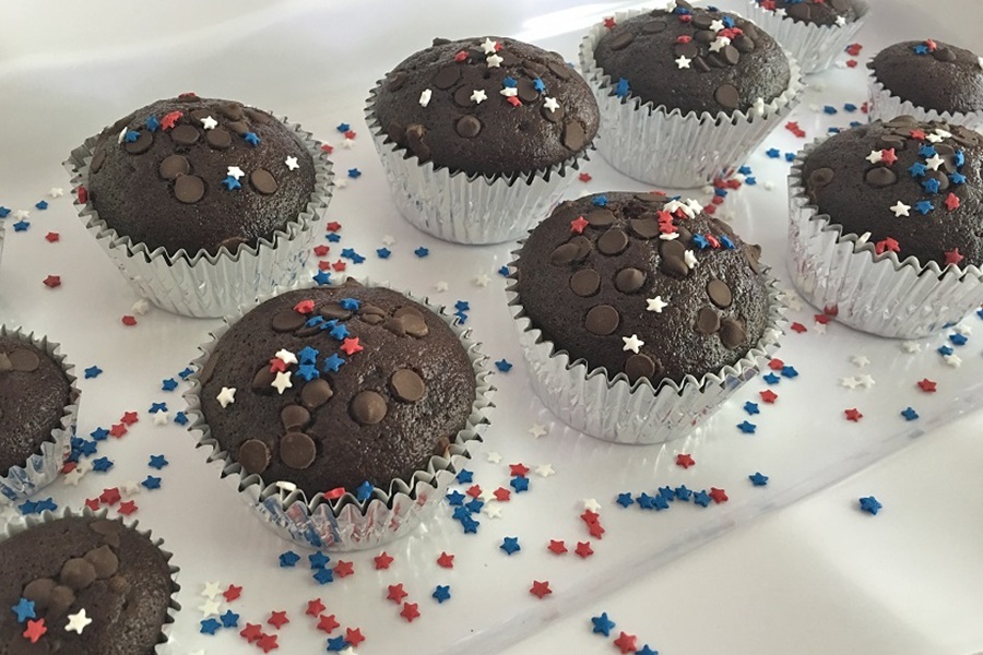 Easy Chocolate Dairy Free Cupcakes Two Rows of Cupcakes on a Serving Platter with Red, White and Blue Sprinkles All Around