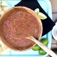 Homemade Salsa Recipe Overhead View of a Bowl of Salsa on a Platter with Tortilla Chips and Napkins