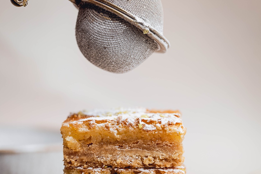 Lemon Bar Recipe Lemon Bars Being Dusted with Powdered Sugar
