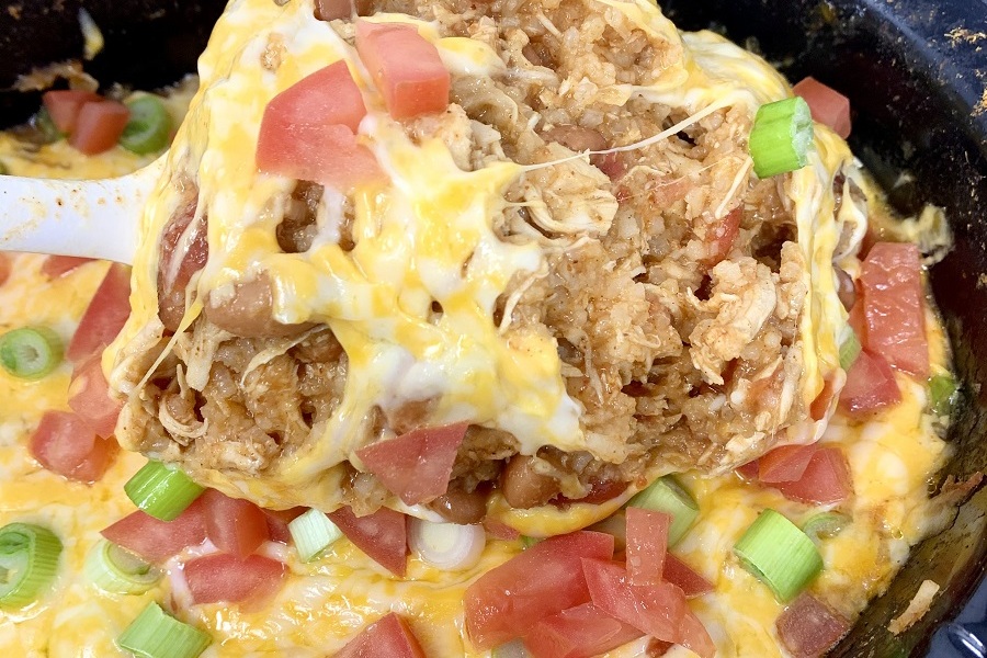 Easy Chicken Burrito Bowl Recipe Close Up of a Scoop of Burrito Filling Coming From a Crock Pot