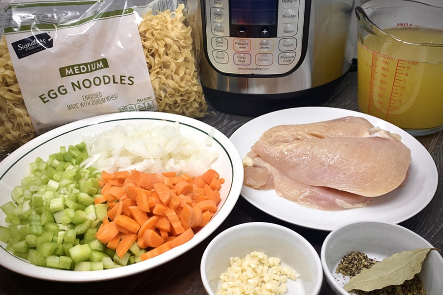 Quick Chicken Noodle Soup Ingredients Separated into Bowls and Plates