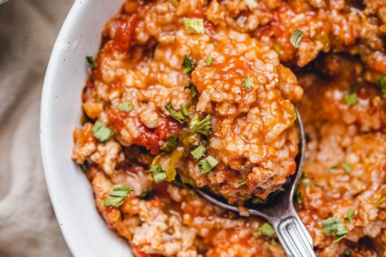St Patrick's Day Crockpot Recipes Close Up of Unstuffed Cabbage Rolls in a White Bowl with a Spoon