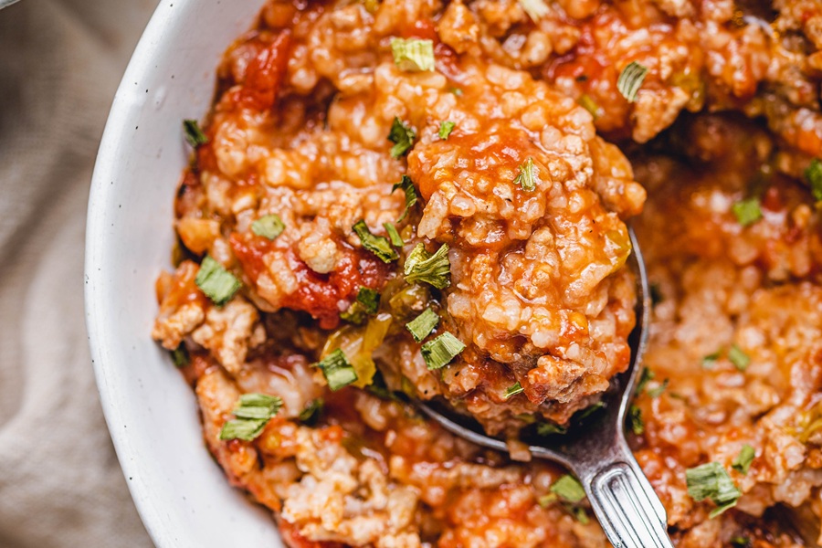 St Patrick's Day Crockpot Recipes Close Up of Unstuffed Cabbage Rolls in a White Bowl with a Spoon