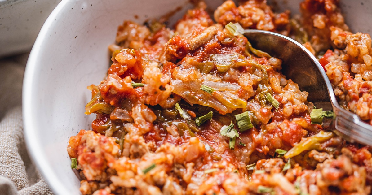 St Patrick's Day Crockpot Recipes Crockpot Unstuffed Cabbage Rolls Recipe in a White Bowl with a Spoon