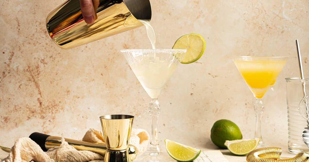 National Margarita Day Recipes a Nearly Norcal Margarita Being Poured into a Martini Glass from a Shaker and a Lime Slice on the Martini Glass Rim
