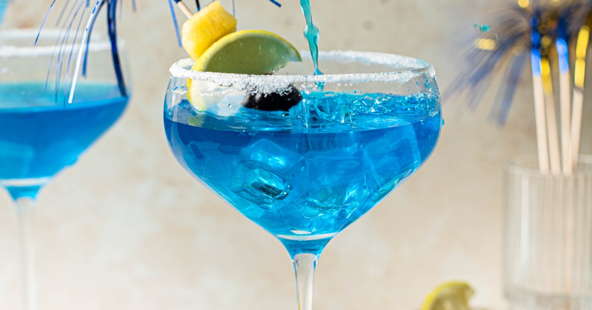 National Margarita Day Recipes Close Up of a Blue Mermaid Margarita Garnished with a Lemon Wedge